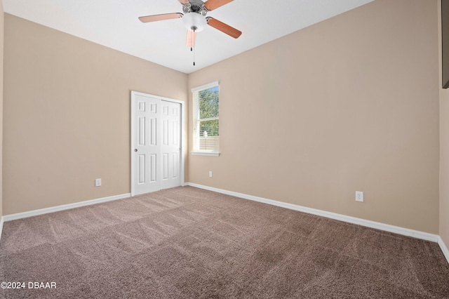 spare room featuring carpet and ceiling fan