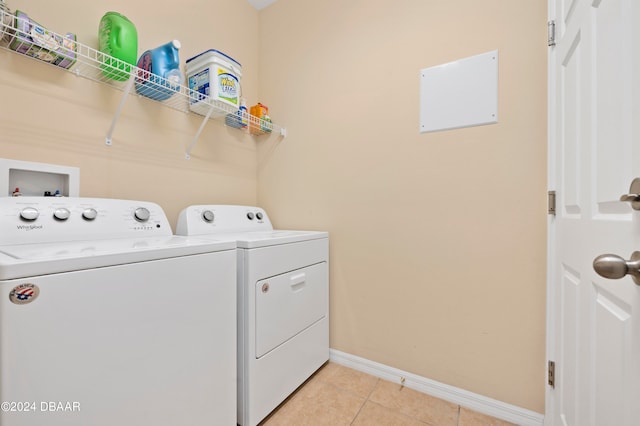 washroom featuring light tile patterned floors and washing machine and clothes dryer