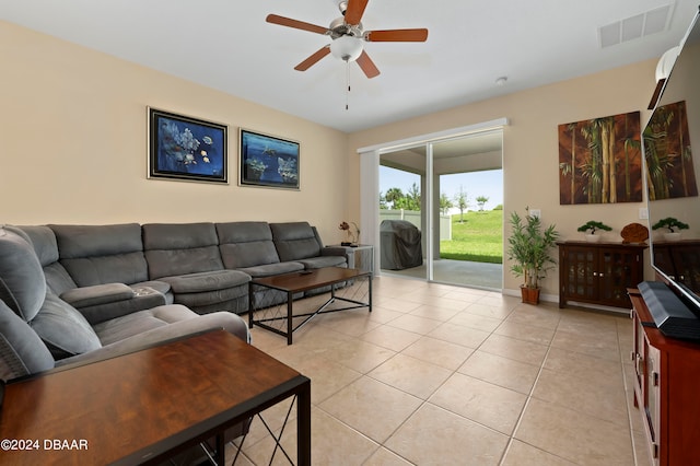 living room featuring ceiling fan and light tile patterned floors