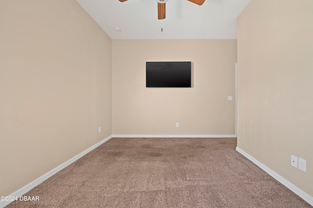 carpeted spare room with ceiling fan