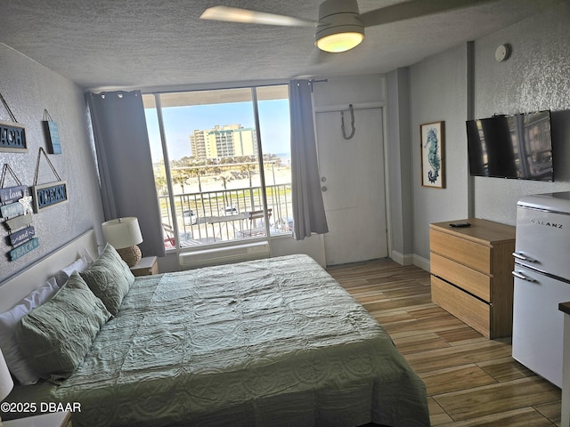 bedroom featuring a textured ceiling and access to outside