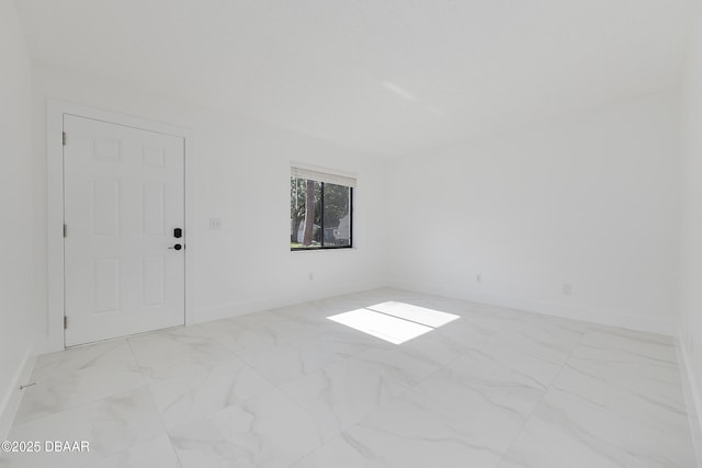252 Manhattan Way, Port Orange, FL 32129 - empty room with baseboards and marble look tile flooring