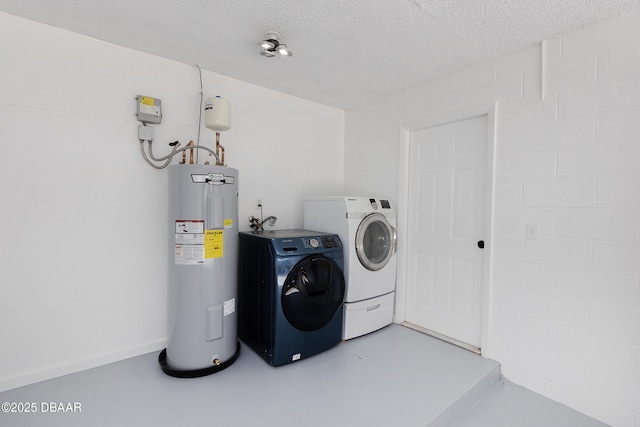 252 Manhattan Way, Port Orange, FL 32129 - washroom with washer and clothes dryer, electric water heater, and a textured ceiling