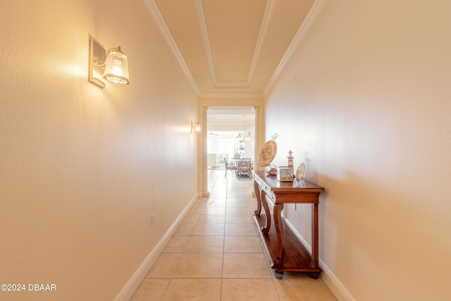 hall featuring ornamental molding and light tile patterned floors