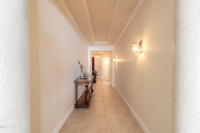 hallway with light tile patterned floors and crown molding