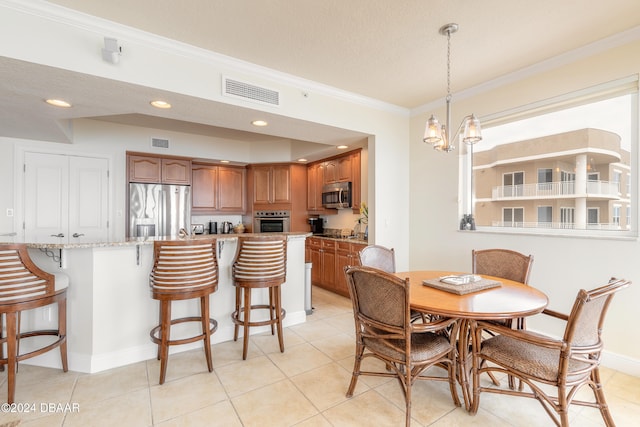 dining room featuring a textured ceiling, a chandelier, light tile patterned floors, and crown molding