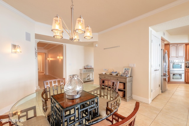 tiled dining room featuring decorative columns, an inviting chandelier, and ornamental molding