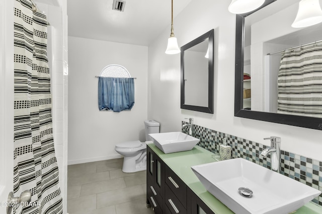 bathroom with tasteful backsplash, walk in shower, vanity, and toilet