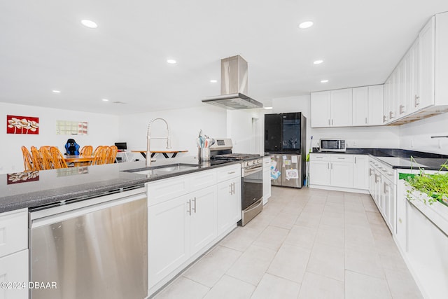 kitchen with island exhaust hood, sink, white cabinets, and stainless steel appliances