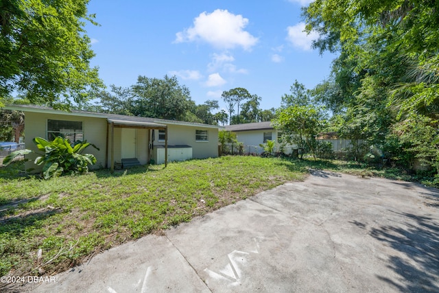 rear view of house featuring a lawn