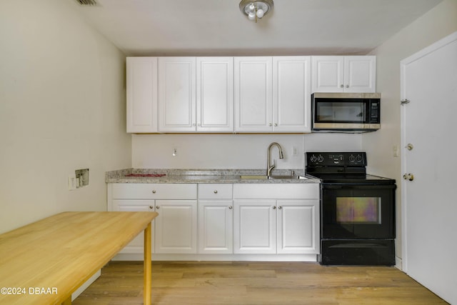 kitchen with white cabinetry, black range with electric cooktop, and light hardwood / wood-style floors