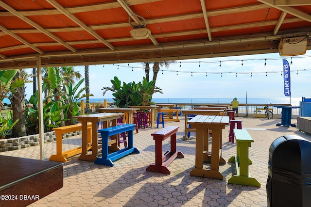 view of patio featuring grilling area and a water view