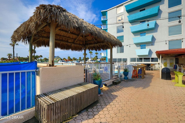 view of patio / terrace featuring a pool and a gazebo