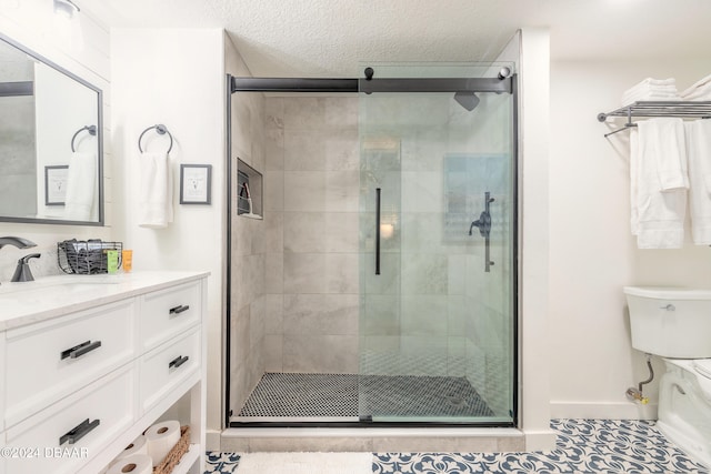 bathroom with walk in shower, vanity, and tile patterned floors