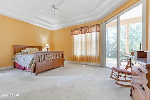 bedroom featuring ceiling fan, access to exterior, multiple windows, and carpet flooring