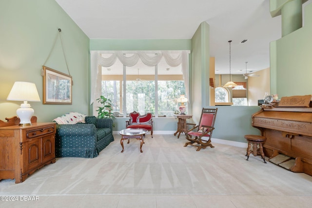 sitting room with ceiling fan and light tile patterned floors