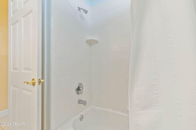 bathroom with shower / bath combo with shower curtain