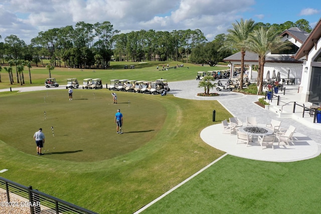 view of community featuring a fire pit and a patio area