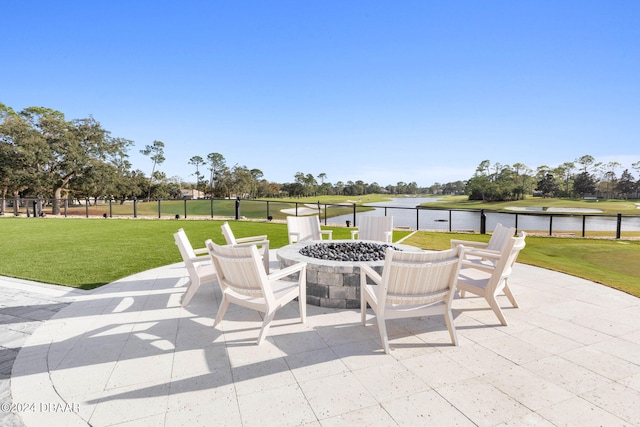 view of patio / terrace featuring a water view and an outdoor fire pit