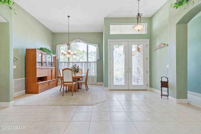 interior space with french doors and a notable chandelier