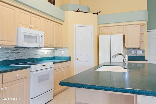 kitchen with light brown cabinetry, sink, white appliances, and backsplash