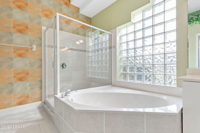 bathroom featuring vanity, tile patterned flooring, plenty of natural light, and separate shower and tub