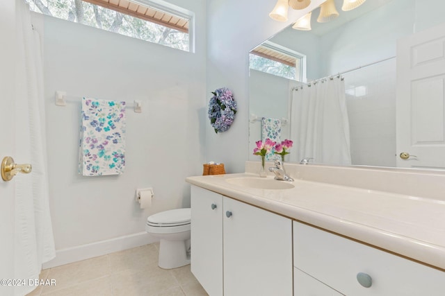 bathroom with tile patterned flooring, curtained shower, vanity, and toilet