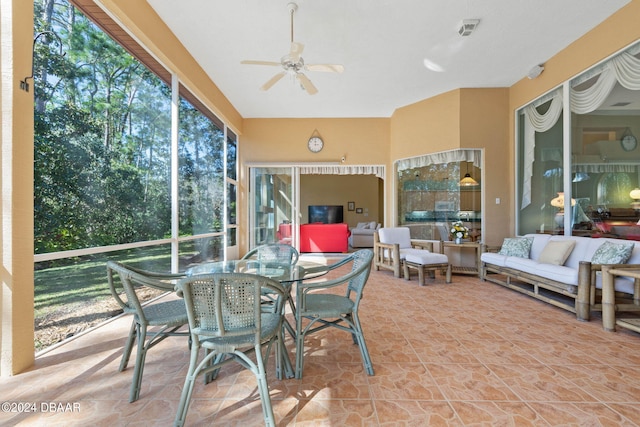 sunroom / solarium featuring ceiling fan