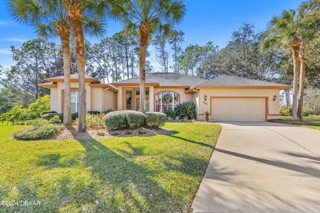 view of front of property with a garage and a front yard