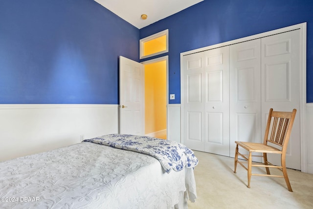 bedroom with light colored carpet and a closet