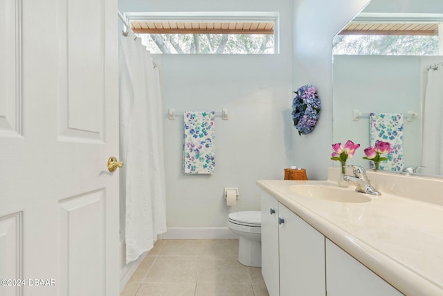 bathroom featuring toilet, vanity, and tile patterned floors