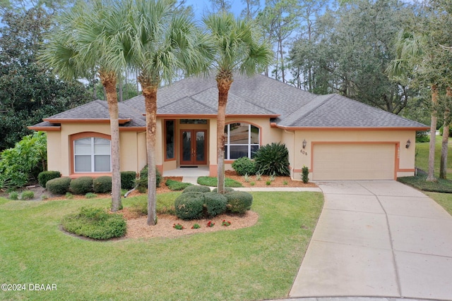 view of front of home featuring a garage and a front lawn