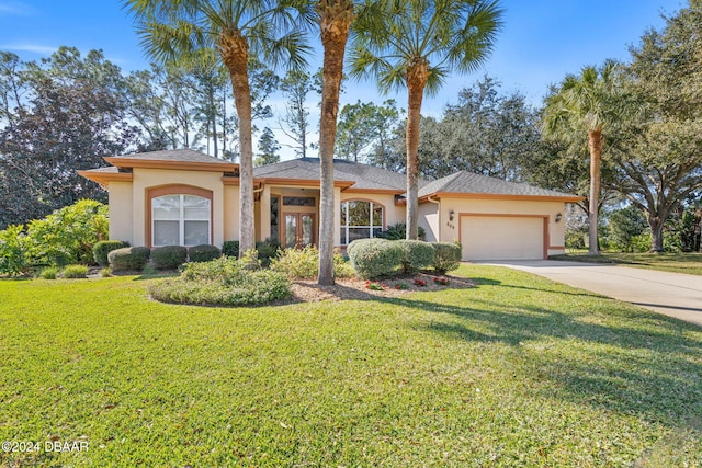 view of front of house featuring a front lawn and a garage