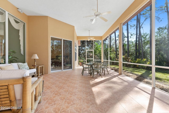 unfurnished sunroom with ceiling fan