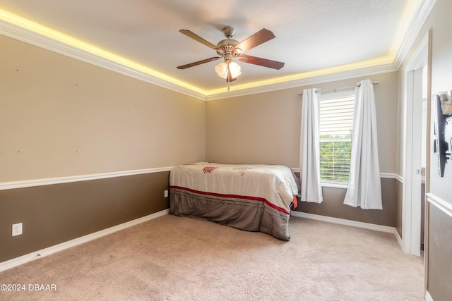 carpeted bedroom featuring ceiling fan and crown molding