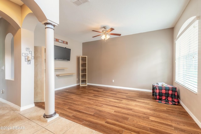 206 Laurel Point Ct, Deland, FL 32724 - unfurnished living room featuring a ceiling fan, light wood-style flooring, decorative columns, and baseboards