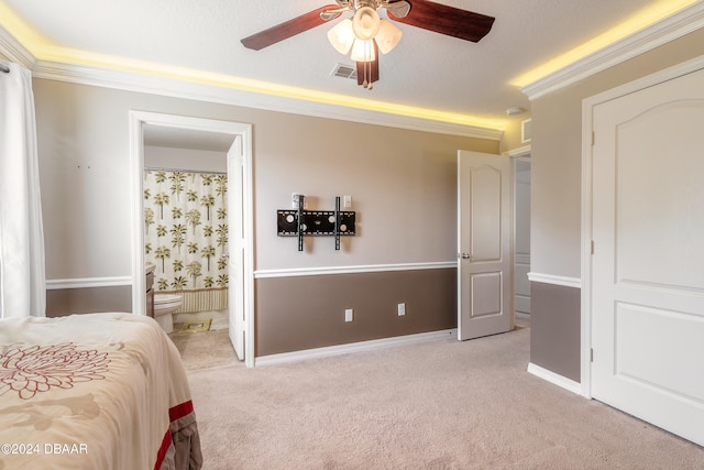 bedroom with light carpet, ornamental molding, ensuite bathroom, ceiling fan, and a textured ceiling