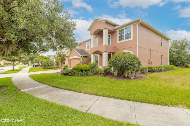 view of front of property with a garage and a front lawn