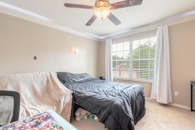 carpeted bedroom featuring ceiling fan and crown molding