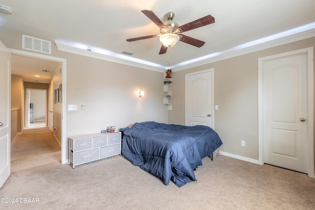 bedroom featuring ornamental molding, light colored carpet, and ceiling fan