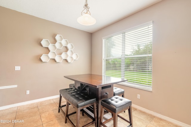 dining room featuring a healthy amount of sunlight and light tile patterned flooring