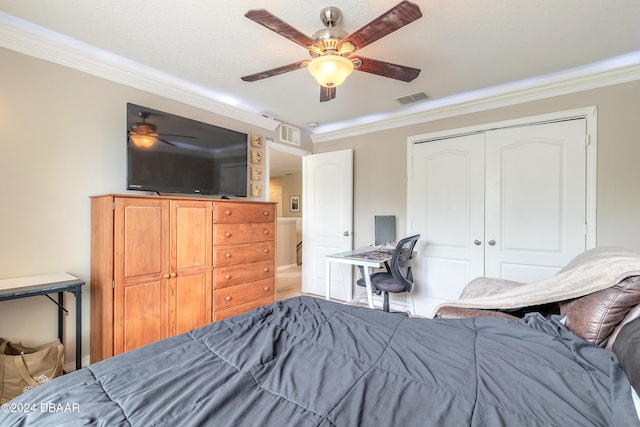 bedroom featuring ceiling fan, a textured ceiling, a closet, and crown molding