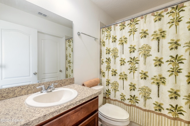 bathroom featuring vanity, a textured ceiling, toilet, and a shower with curtain