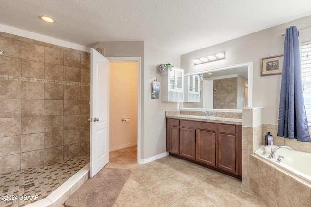 bathroom featuring vanity, independent shower and bath, tile patterned flooring, and a textured ceiling