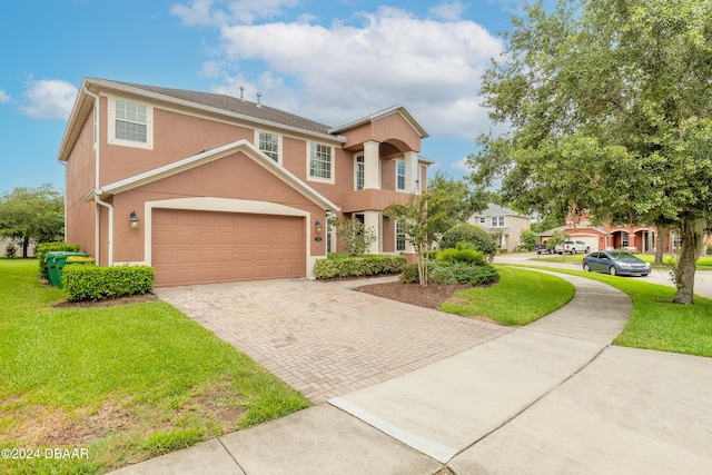 view of front of property with a garage and a front yard