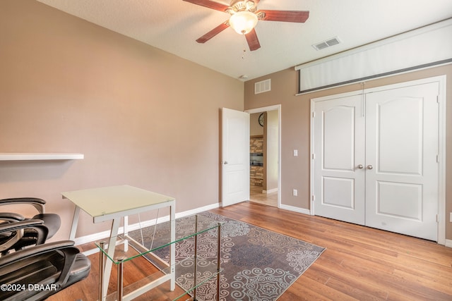 office featuring ceiling fan, a textured ceiling, and light hardwood / wood-style flooring