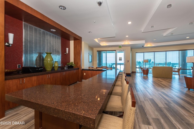 kitchen with hardwood / wood-style flooring and a raised ceiling