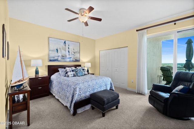 carpeted bedroom featuring ceiling fan, a closet, and access to outside