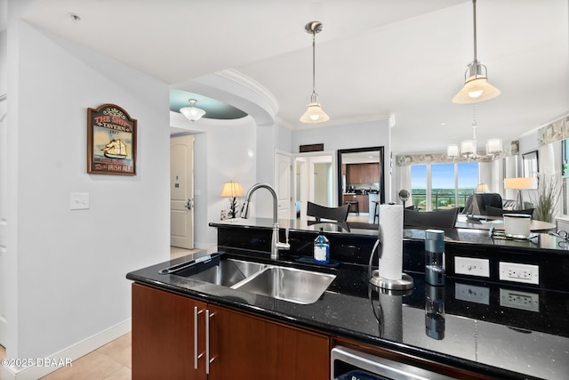 kitchen featuring dishwasher, sink, dark stone countertops, hanging light fixtures, and crown molding