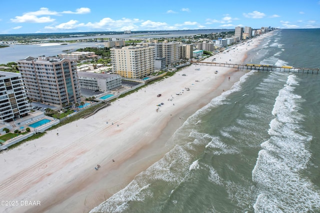 aerial view with a water view and a beach view